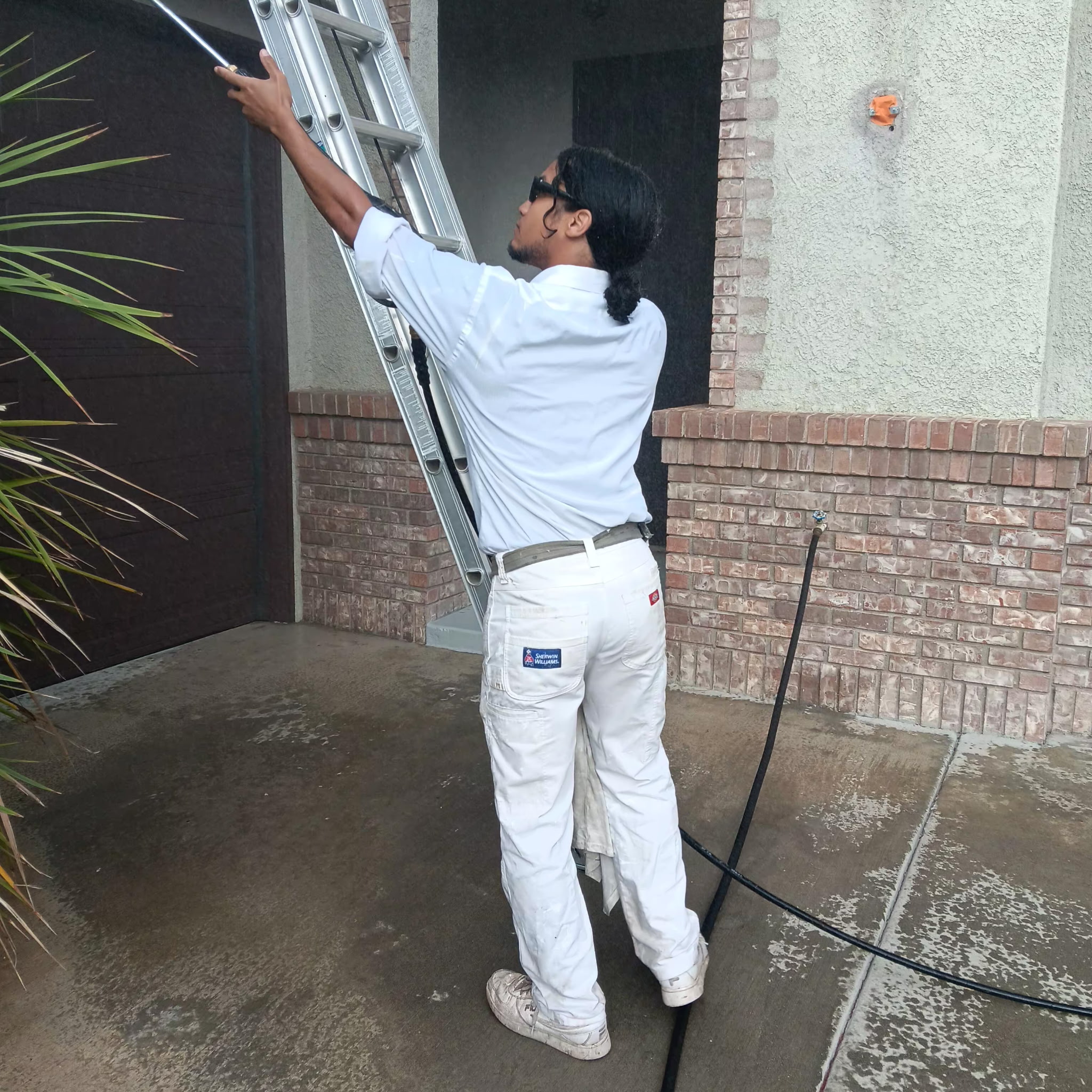 Painter setting up ladder for exterior work
