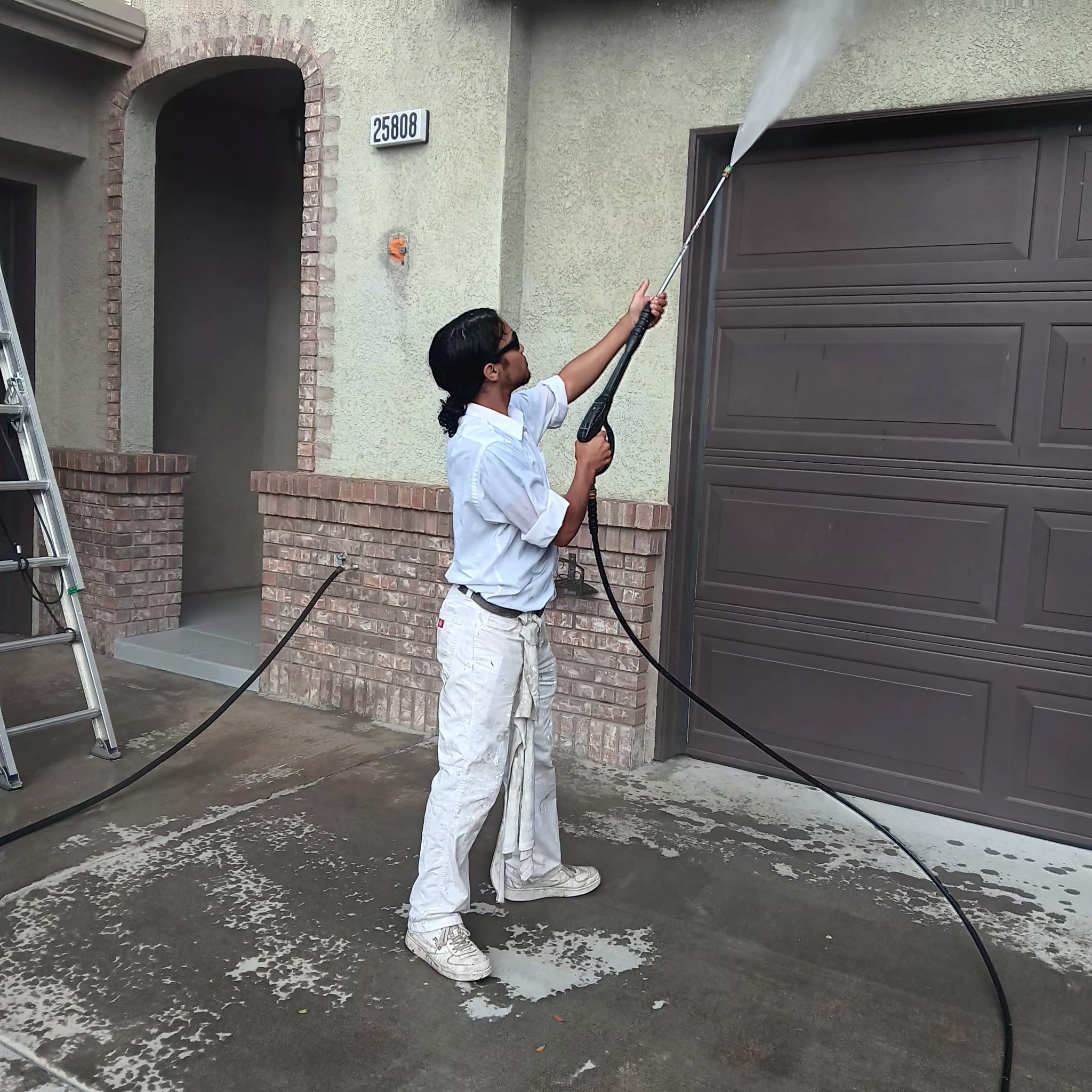 American Paint professional spraying exterior of home